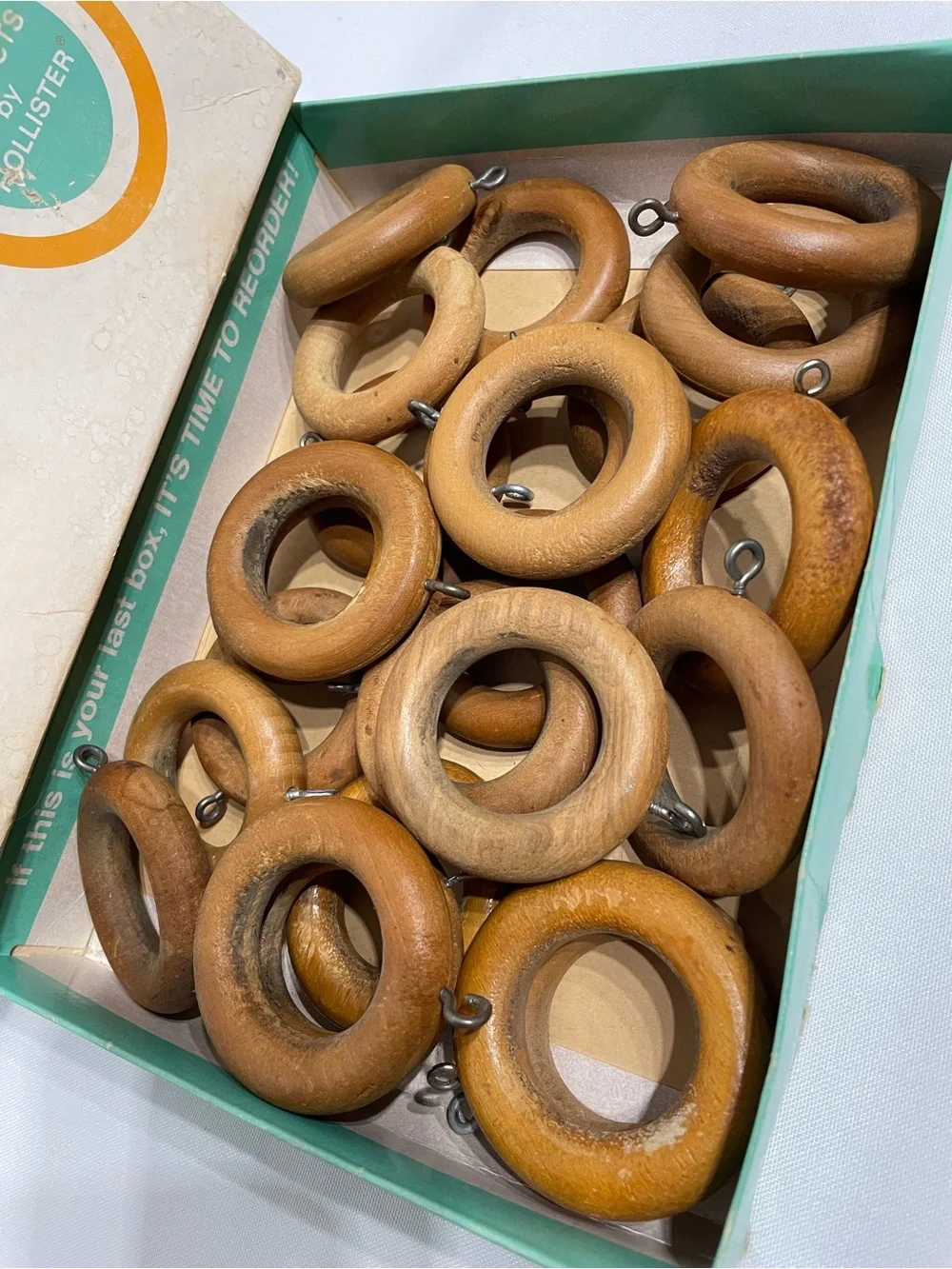 Set of 24 vintage wooden curtain rings feature metal screw eyes for drapery